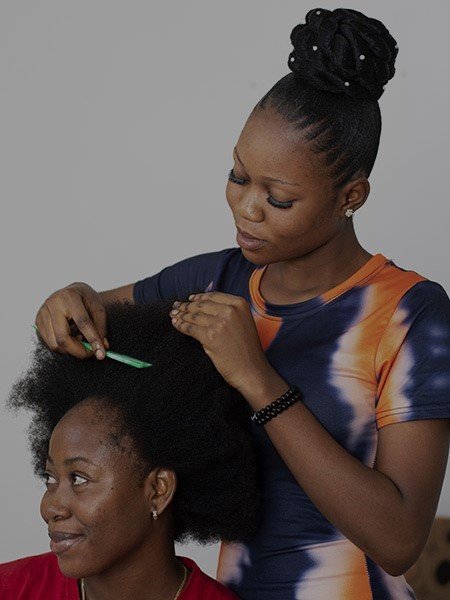 An african beautician attending to a client