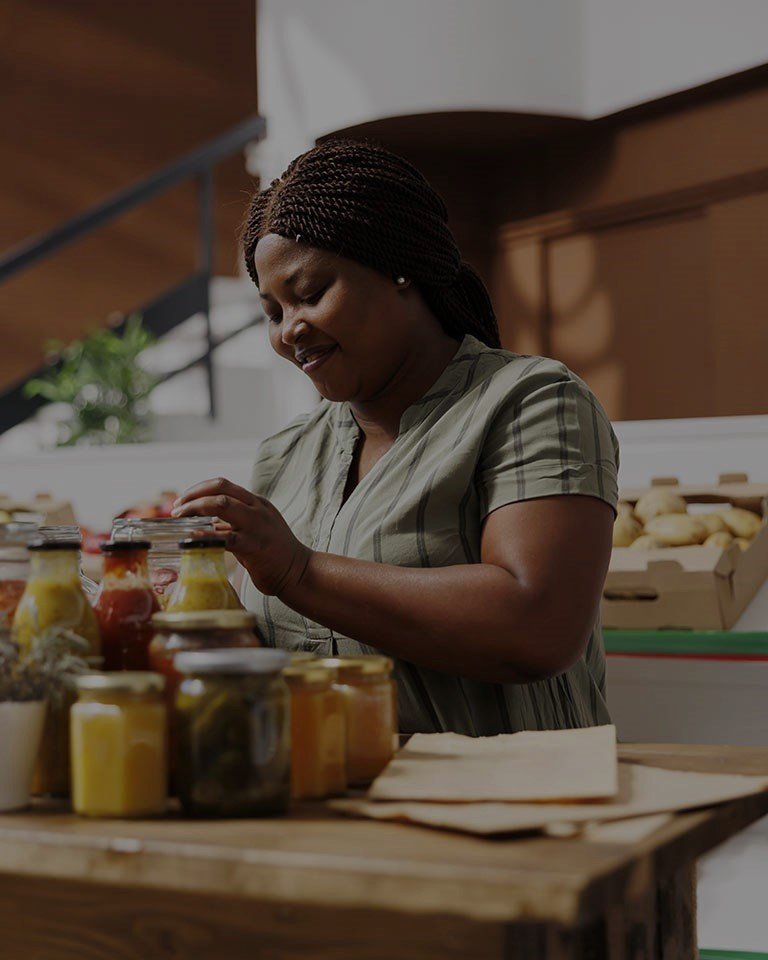 woman bottling fruit juice for local business