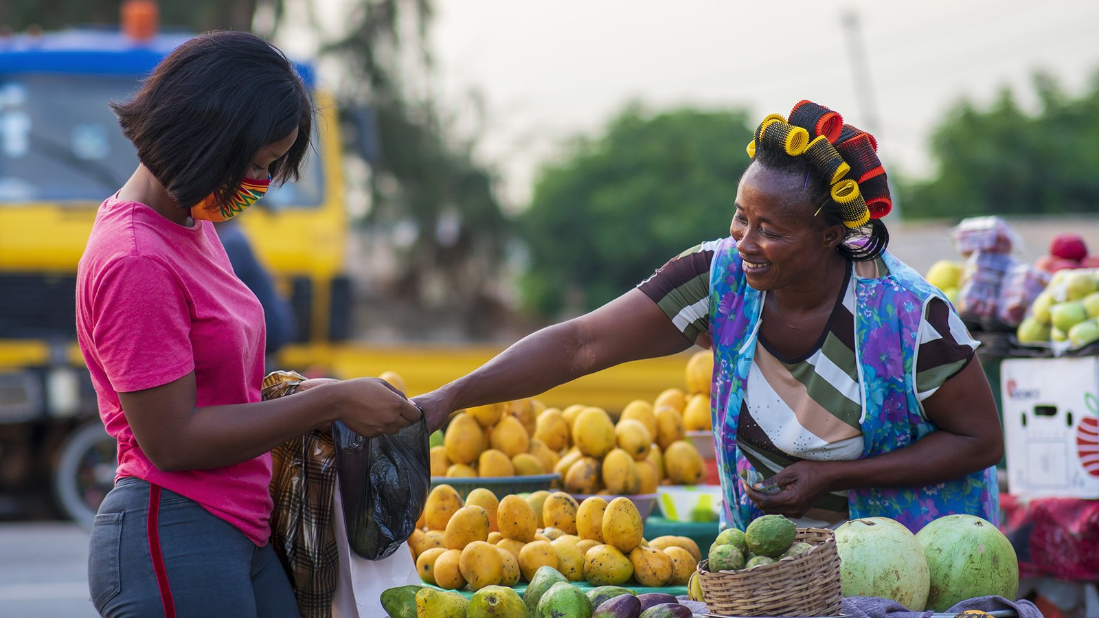 african woman shopping at a fruit market